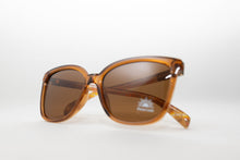 Load image into Gallery viewer, Brown sunglasses with a polarized visible sticker on a white background