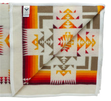 Load image into Gallery viewer, Pendleton Chief Joseph Blanket in Ivory featuring a traditional Native American-inspired geometric pattern with arrow motifs, folded neatly to show intricate design and soft wool texture, inside view