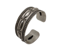 Load image into Gallery viewer, Artisan sterling silver cuff bracelet with raised repousse ovals and hand-stamped geometric detailing in a heritage Southwestern style.