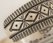Load image into Gallery viewer, Close-up of a silver ring with intricate geometric design