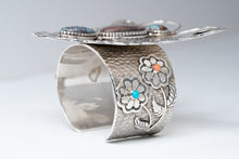 Load image into Gallery viewer, Standing Side View of Bracelet, two silver flowers with one stone each, Sleeping beauty Turquoise, and a pink coral stone