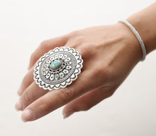 Load image into Gallery viewer, Native American sterling silver ring with a turquoise stone on a hand against a white background
