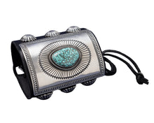 Load image into Gallery viewer, A bold leather bowguard adorned with a rectangular sterling silver faceplate, finely stamped in a sunburst motif framing a sky-blue Kingman turquoise stone with dark matrix. Embellished with fan-pattern silver conchos on both sides and tied with a black leather cord.