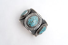 Load image into Gallery viewer, Top view of a silver cuff bracelet with 3 turquoise gemstones on a white background
