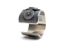 Load image into Gallery viewer, Silver cuff bracelet with circular textured design on a white background