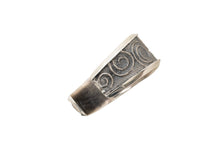 Load image into Gallery viewer, Side view of a silver cuff bracelet with spiral pattern on a white background