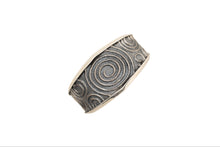 Load image into Gallery viewer, Silver cuff bracelet with spiral pattern on a white background