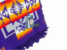 Load image into Gallery viewer, Pendleton Chief Joseph Blanket in purple featuring a traditional Native American-inspired geometric pattern with arrow motifs, folded neatly to show intricate design and soft wool texture, tag view