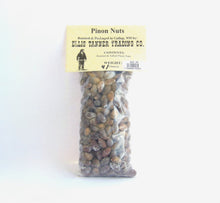 Load image into Gallery viewer, A clear plastic package containing 4 ounces of roasted piñon nuts, with a label displaying the brand name, product name, and weight.