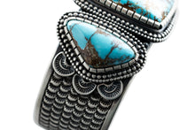 Load image into Gallery viewer, Close up of Royston side triangle stone and silver overlay stamping, by Navajo Silversmith Matthew Charley, with a solid white background.