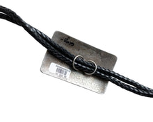 Load image into Gallery viewer, Black leather cord being looped through two silver circular loops on the back of a rectangular bolo tie