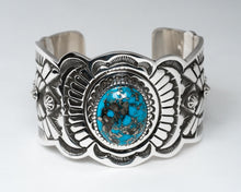 Load image into Gallery viewer, A silver-stamped cuff bracelet featuring a central Persian turquoise gemstone, with intricate hand-stamped designs around it.