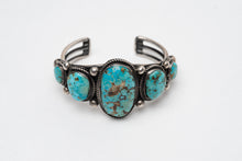 Load image into Gallery viewer, Native American bracelet with one large turquoise stone in the center with 2 more smaller turquoise stones on each side on a white background