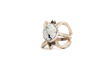 Load image into Gallery viewer, Silver cast cut-out ring showcases a single, centrally set round white buffalo stone. Ring appears gold because of the natural patina