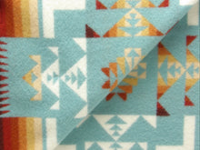 Load image into Gallery viewer, Pendleton Chief Joseph shawl in aqua, featuring a traditional Native American-inspired geometric pattern with arrow motifs, folded neatly to show intricate design and soft wool texture, Inside View