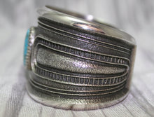 Load image into Gallery viewer, A bold sand-cast cuff featuring intricate textures and patterns, Side Profile,