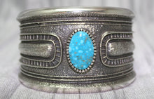 Load image into Gallery viewer, A bold sand-cast cuff featuring intricate textures and patterns, with a bright Kingman Turquoise