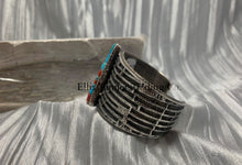 Load image into Gallery viewer, Displayed is the side of a silver tufa cobbletone bracelet, on a silver shiny sheet,