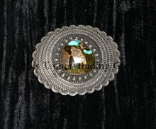 Load image into Gallery viewer, A silver belt buckle with a Royston turquoise centerpiece and intricate button details on a black background.