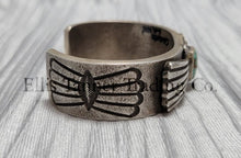 Load image into Gallery viewer, Heavy silver bracelet, with a center Carico Lake Turquoise stone, with an overlay design, on top of a shiny silver sheet