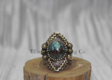 Load image into Gallery viewer, Silver, with zigzag 14k overlay design with round Bisbee turquoise in center, on wooden display