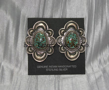 Load image into Gallery viewer, Silver stamped clip on earrings, with a center #8 Turquoise surrounded by a silver rope. displayed on a black card on top of a silver sheet