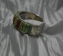 Load image into Gallery viewer, A silver bracelet featuring an intricate cobblestone inlay design with vibrant Carico Lake turquoise and coral stones. The piece is displayed on a soft, textured silver-gray fabric, side profile