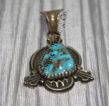 Load image into Gallery viewer, Silver Pendant, over lay silver with hand stamped designs. A center Kingman stone surrounded by a silver bezel. placed on top of a shiny cloth