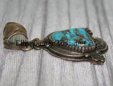 Load image into Gallery viewer, Silver Pendant, over lay silver with hand stamped designs. A center Kingman stone surrounded by a silver bezel. placed on top of a shiny cloth