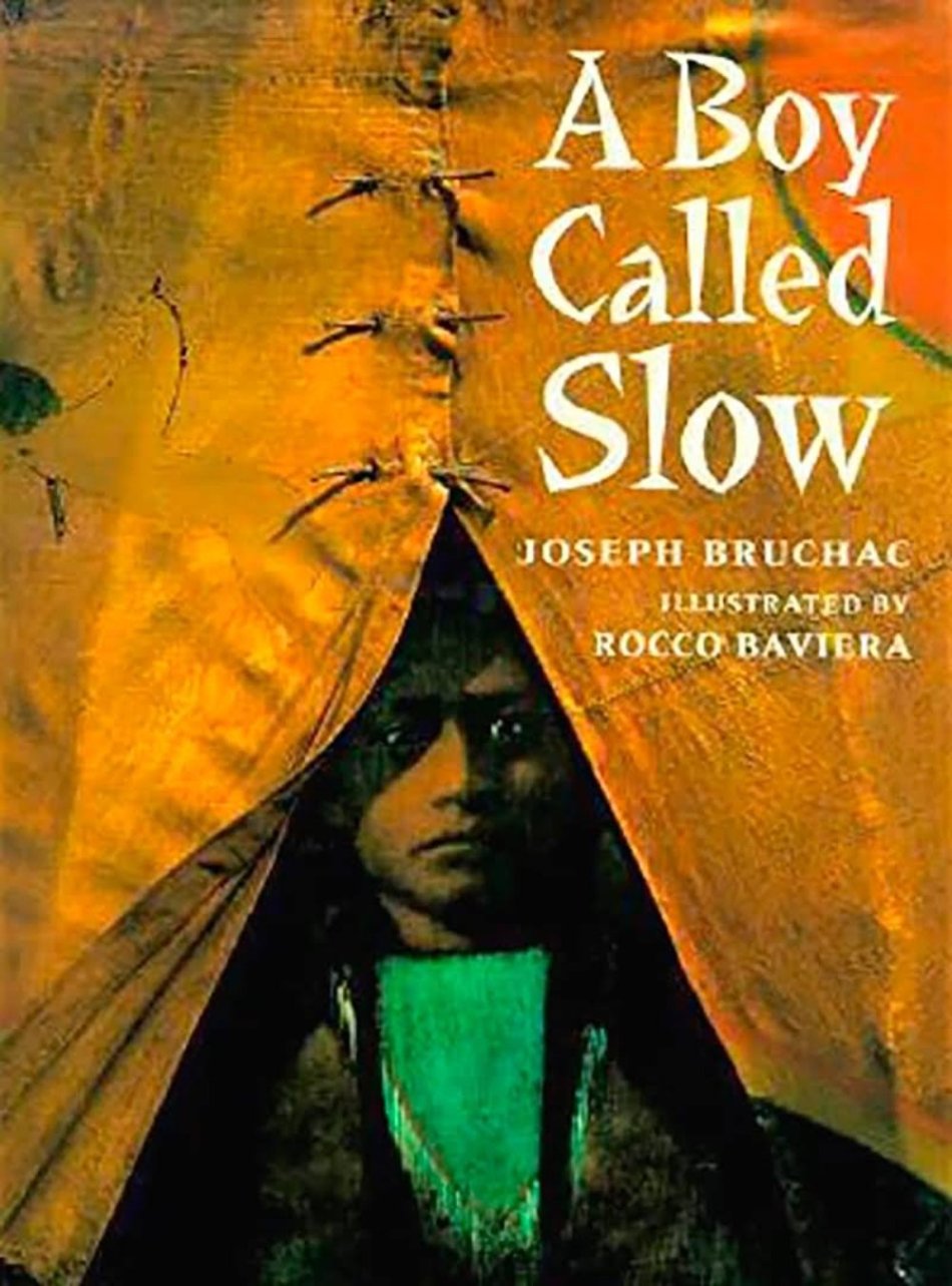 Cover of the book 'A Boy Called Slow' by Joseph Bruchac with illustrations by Rocco Baviera, featuring a young person peeking out from behind a tear in a blanket.