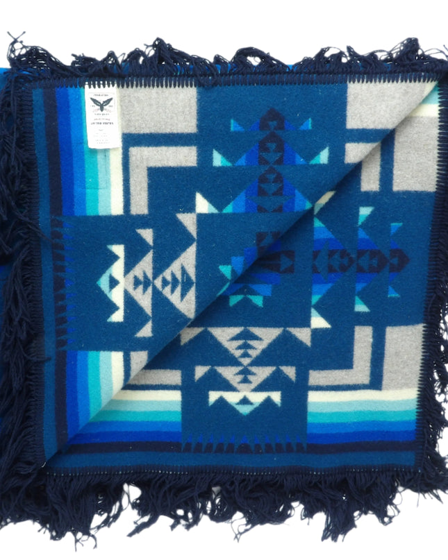 Pendleton Chief Joseph Blanket in Aegean featuring a traditional Native American-inspired geometric pattern with arrow motifs, folded neatly to show intricate design and soft wool texture, Inside View