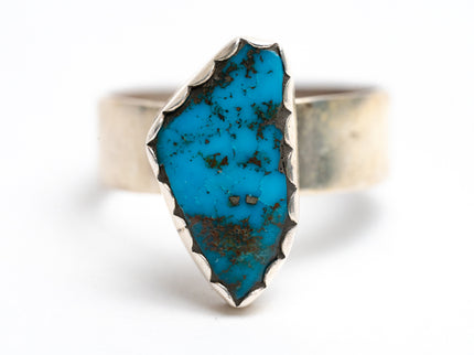 Turquoise ring with silver band on a white background