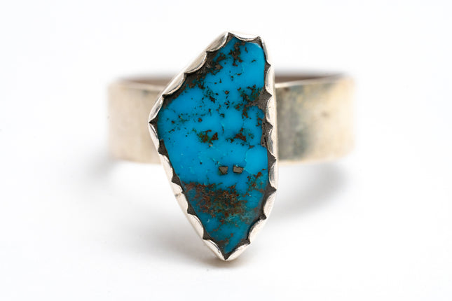Turquoise ring with silver band on a white background
