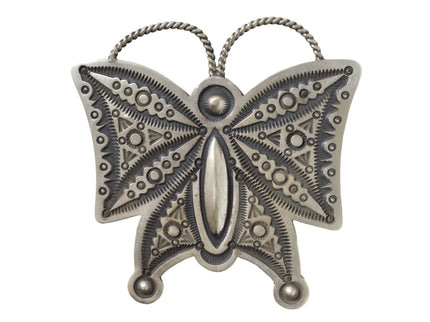 Hand stamped silver butterfly pendant on a white background