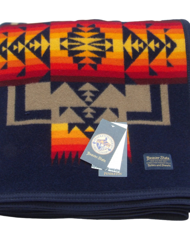 Pendleton Chief Joseph Blanket in Indigo, featuring a traditional Native American-inspired geometric pattern with arrow motifs, folded neatly to show intricate design and soft wool texture. front View 