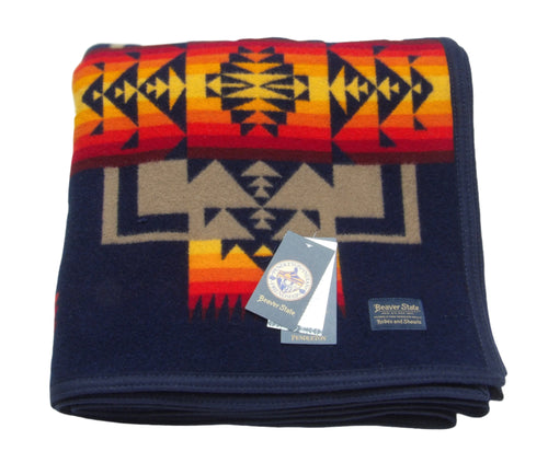 Pendleton Chief Joseph Blanket in Indigo, featuring a traditional Native American-inspired geometric pattern with arrow motifs, folded neatly to show intricate design and soft wool texture. front View 