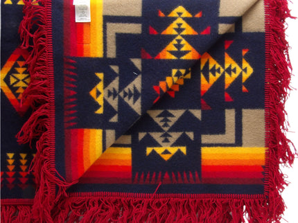 Pendleton Chief Joseph Shawl in indigo, featuring a traditional Native American-inspired geometric pattern with arrow motifs, folded neatly to show intricate design and soft wool texture. Inside view