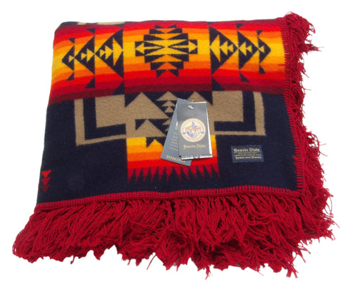 Pendleton Chief Joseph Blanket in indigo, featuring a traditional Native American-inspired geometric pattern with arrow motifs, folded neatly to show intricate design and soft wool texture. Front View 