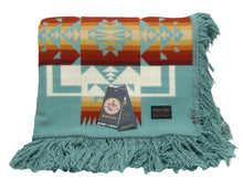 Load image into Gallery viewer, Pendleton Chief Joseph Blanket in aqua, featuring a traditional Native American-inspired geometric pattern with arrow motifs, folded neatly to show intricate design and soft wool texture
