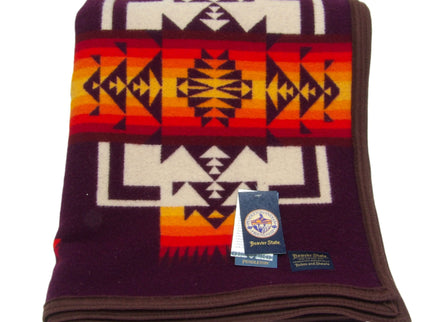 Pendleton Chief Joseph Blanket in Maroon featuring a traditional Native American-inspired geometric pattern with arrow motifs, folded neatly to show intricate design and soft wool texture. front View 