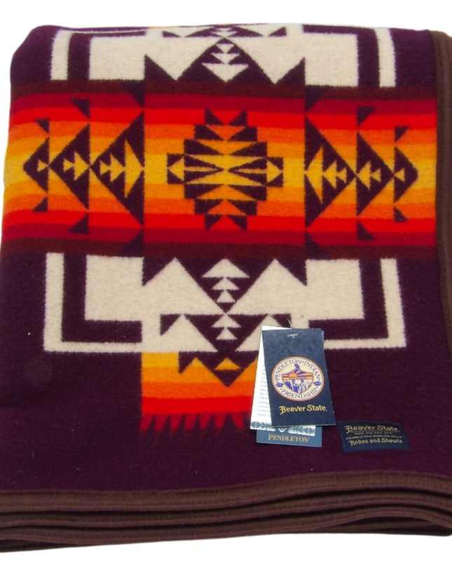 Pendleton Chief Joseph Blanket in Maroon featuring a traditional Native American-inspired geometric pattern with arrow motifs, folded neatly to show intricate design and soft wool texture. front View 