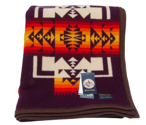 Pendleton Chief Joseph Blanket in Maroon featuring a traditional Native American-inspired geometric pattern with arrow motifs, folded neatly to show intricate design and soft wool texture. front View 