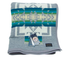 Load image into Gallery viewer, Pendleton Chief Joseph Blanket in Grey featuring a traditional Native American-inspired geometric pattern with arrow motifs, folded neatly to show intricate design and soft wool texture. front View 
