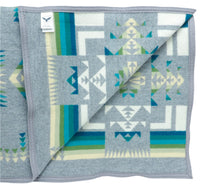 Load image into Gallery viewer, Pendleton Chief Joseph Blanket in grey featuring a traditional Native American-inspired geometric pattern with arrow motifs, folded neatly to show intricate design and soft wool texture, inside view

