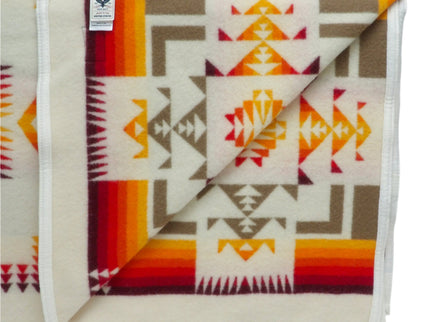 Pendleton Chief Joseph Blanket in Ivory featuring a traditional Native American-inspired geometric pattern with arrow motifs, folded neatly to show intricate design and soft wool texture, inside view