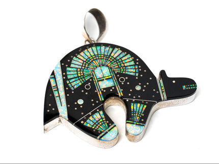 Jet black bear shaped inlay Navajo pendant with a Yei on the surface in opal on white background