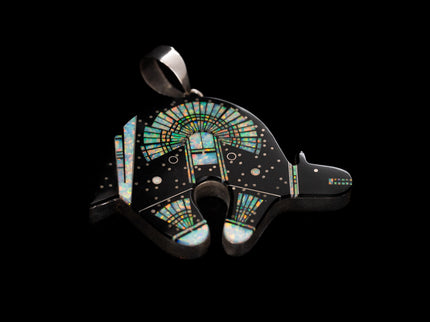 Jet black bear shaped inlay Navajo pendant with a Yei on the surface in opal on a black background