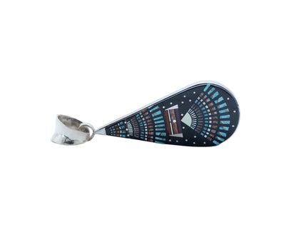Teardrop-shaped pendant with decorative night Sky pattern, placed in a silver plate and silver bail at the top, laying sideways on a white background