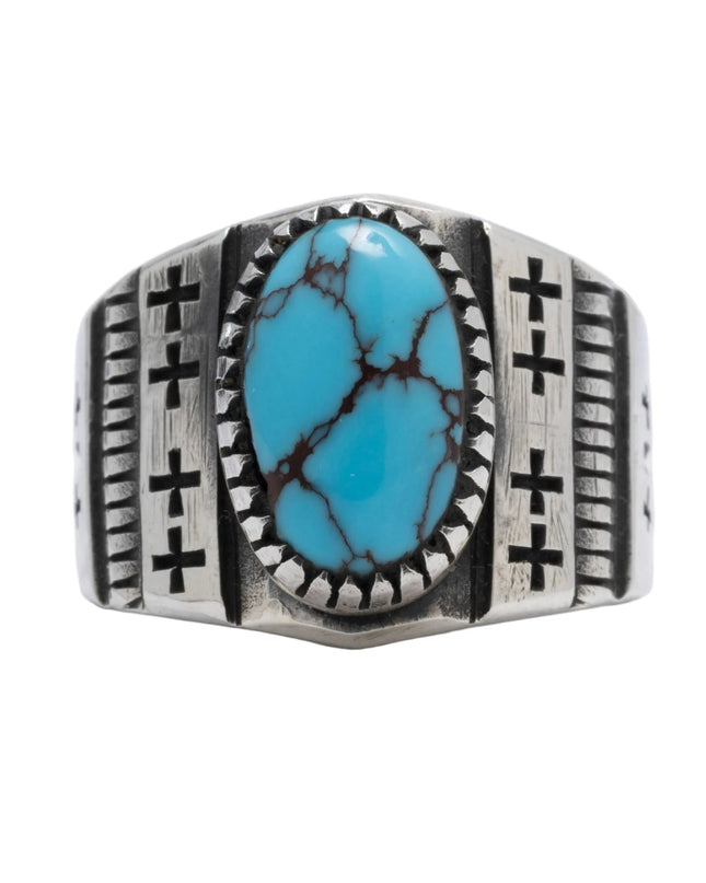 Navajo designed silver ring with one Egyptian turquoise stone and 8 crosses etched on top displayed on a light gray background