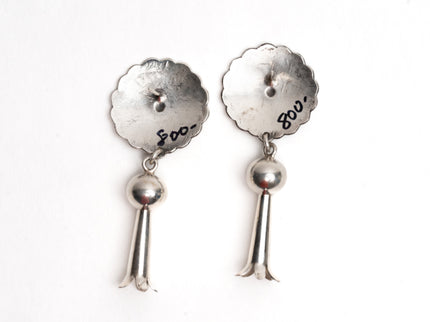 Pair of silver earrings with '800' engraving on a white background